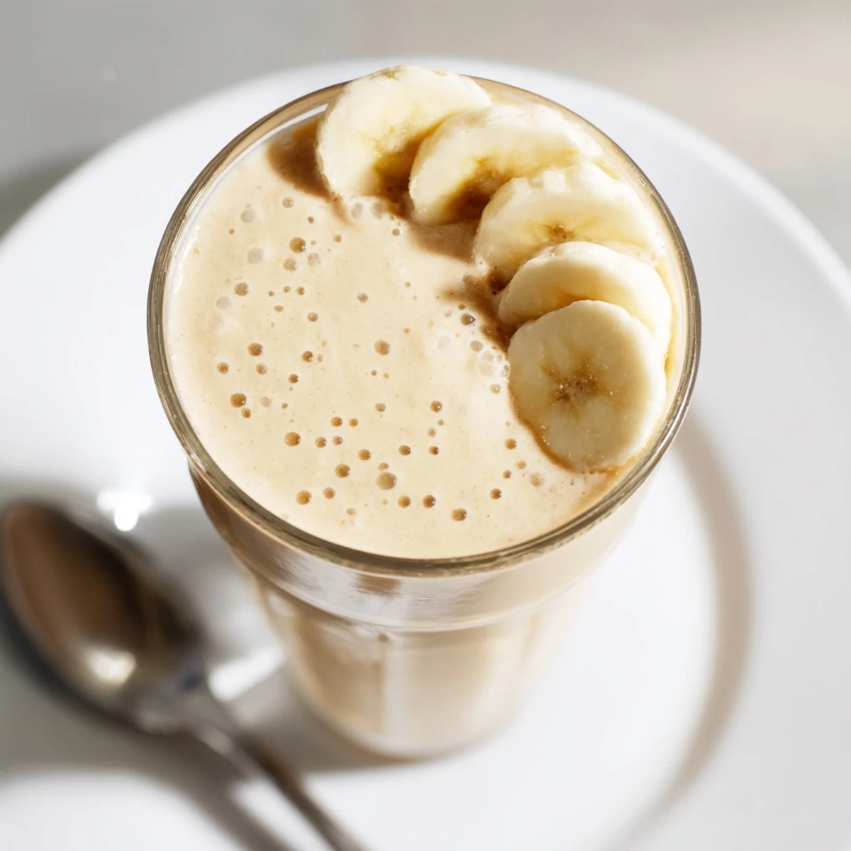 Thick and decadent Peanut Butter Banana Smoothie, with visible ice crystals, perfect for a quick, filling treat.