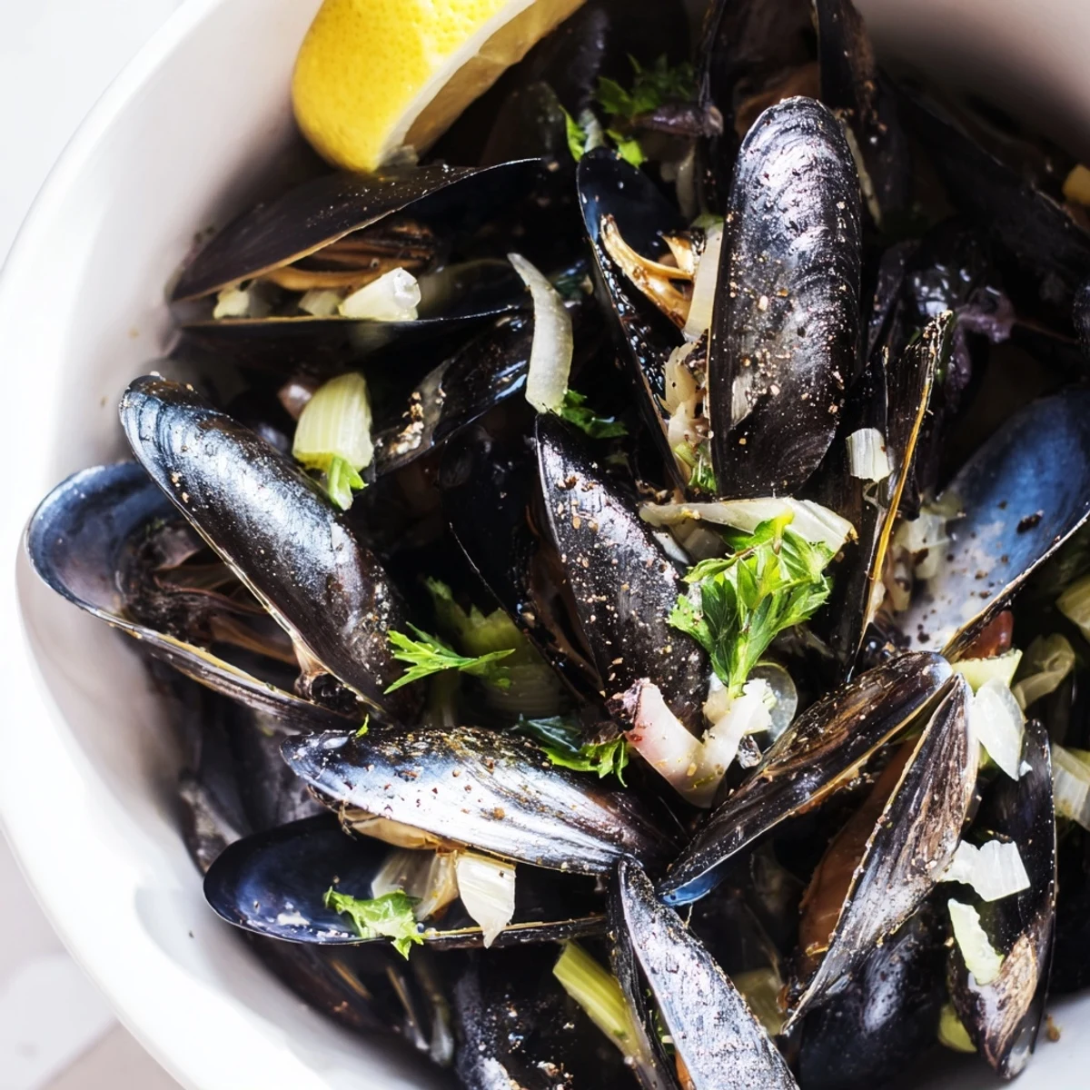 Steaming Belgian Moules Marinière—fragrant broth surrounds succulent mussels; a perfect seafood main.