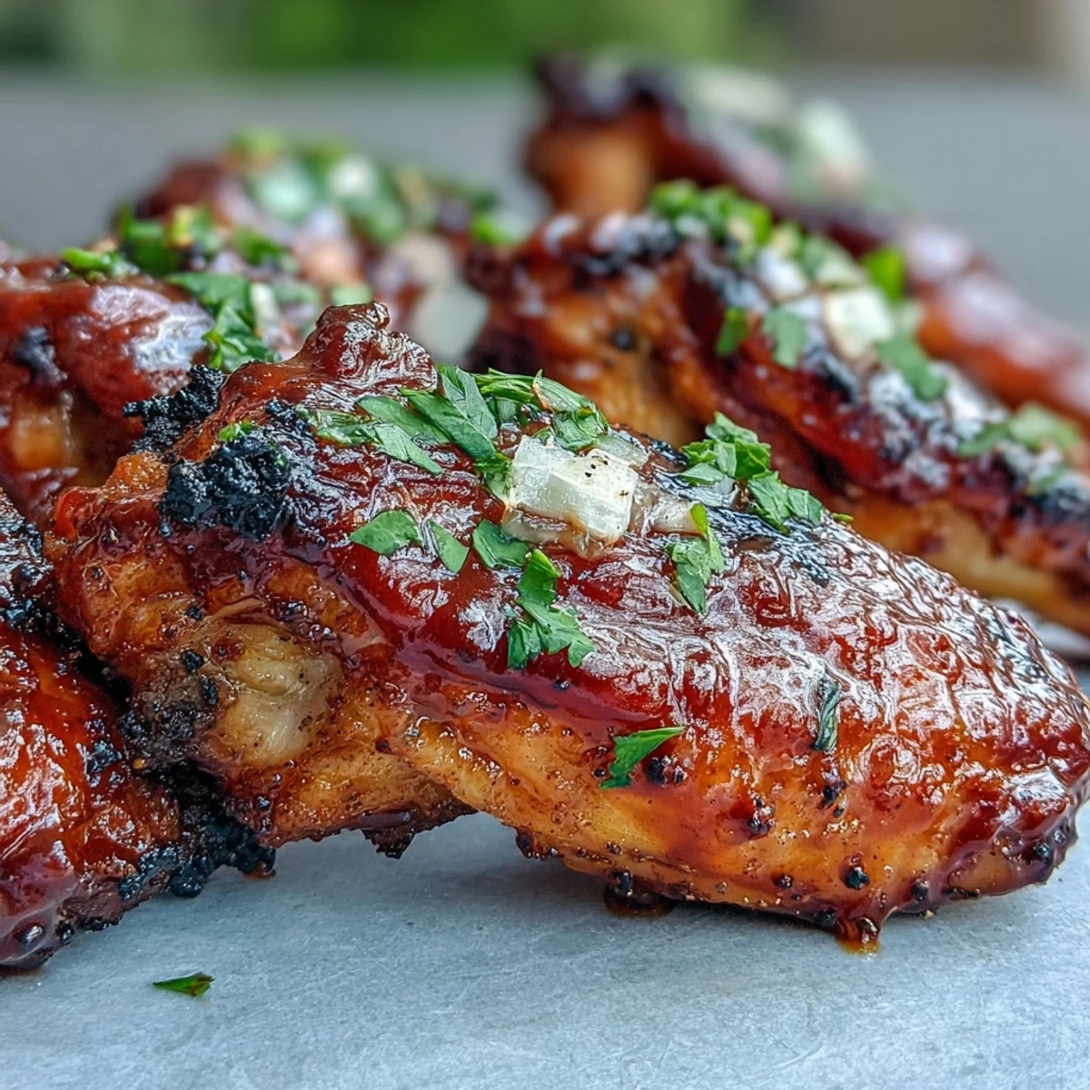 Golden-brown Guava BBQ Glazed Chicken Wings stacked on a platter, ready to be paired with a chilled beer.