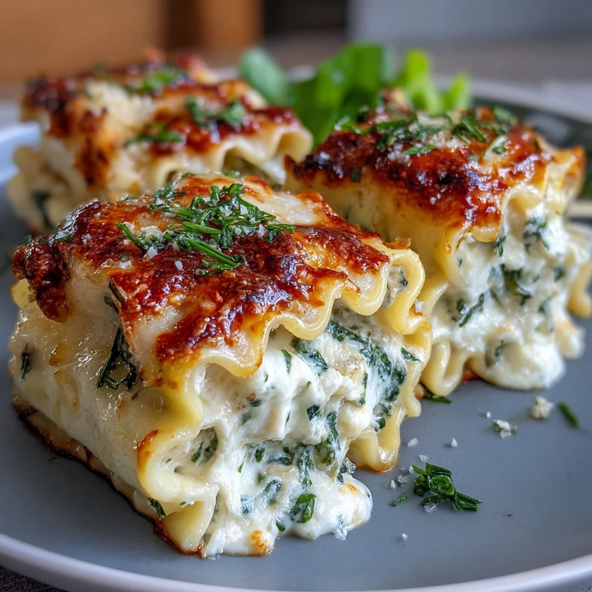 Tender rolled lasagna noodles stuffed with creamy ricotta and spinach, served warm with rich garlic butter sauce.