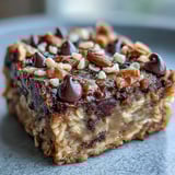 Golden brown Baked Oatmeal Bars are sliced and ready to eat with a glass of milk.