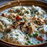 Shredded chicken and vegetables simmered in ranch-seasoned broth under tender drop dumplings for a hearty family dinner.