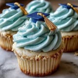 Celebrate graduation with moist vanilla cupcakes topped with buttercream and fondant graduation caps.