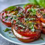 Creamy mozzarella slices paired with ripe tomatoes, fresh basil, and a fragrant homemade basil oil for Caprese salad.