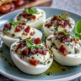 Fresh Caprese Deviled Eggs, beautifully garnished with chopped tomatoes, mozzarella, and basil.