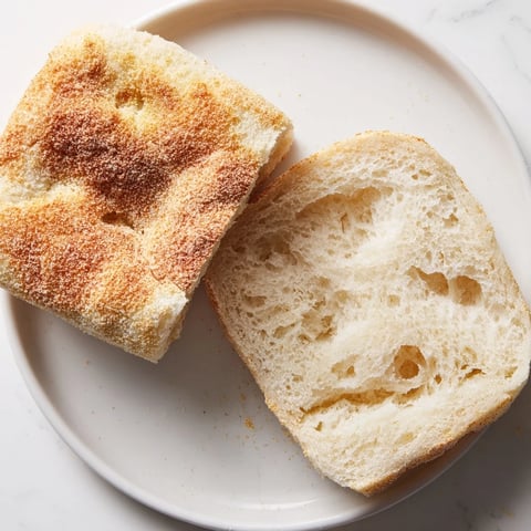 Golden, baked Sheet Pan English Muffins, ready to toast for breakfast with a delightful crumb texture.