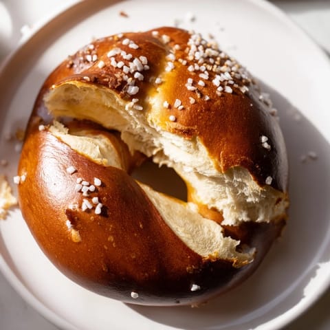 A close-up of freshly baked Homemade Soft Pretzels, showing a perfect, chewy texture and salt.