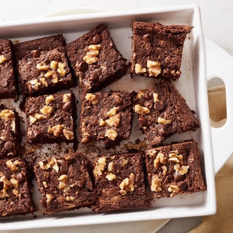 Close-up of baked Fudgy Walnut Brownies, showing a rich, dark chocolate color and textural details.