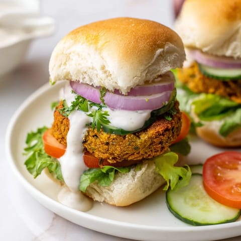 Close-up of crispy, baked falafel patties inside a slider bun, showing off the delicious texture and ingredients.