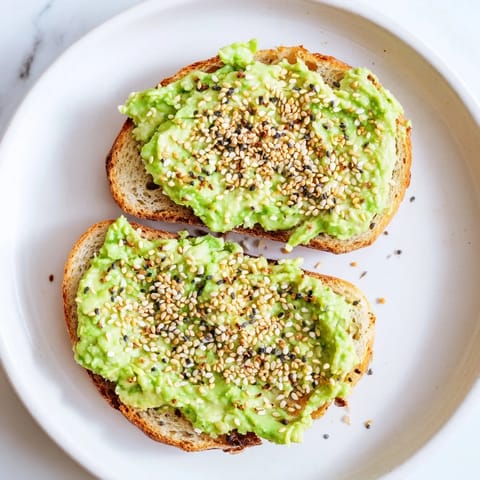 This image shows a vibrant avocado toast with everything, ready to eat, with crispy edges and seasoning.