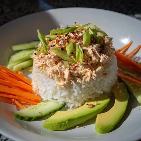 Flavorful Spicy Canned Salmon Rice Bowl features tender flaked salmon over fluffy rice with fresh avocado.