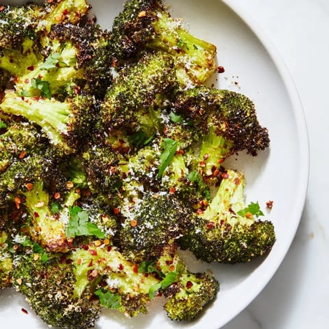 A close-up of Garlic Parmesan Roasted Broccoli, perfectly roasted with melted cheese and garlic.