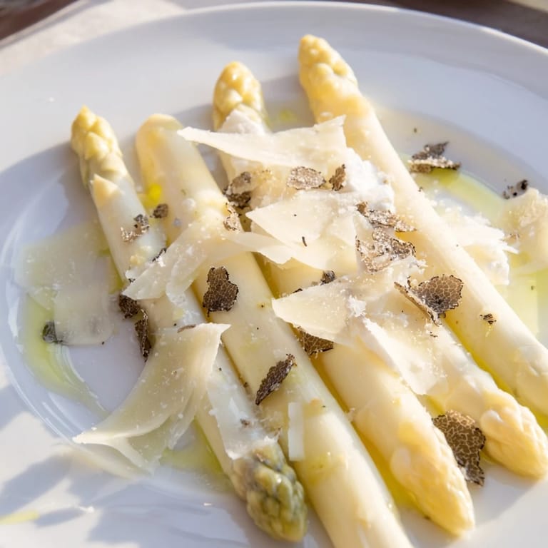 Picture a beautifully plated Silver Birch: white asparagus with shaved Comté and black truffle accents.
