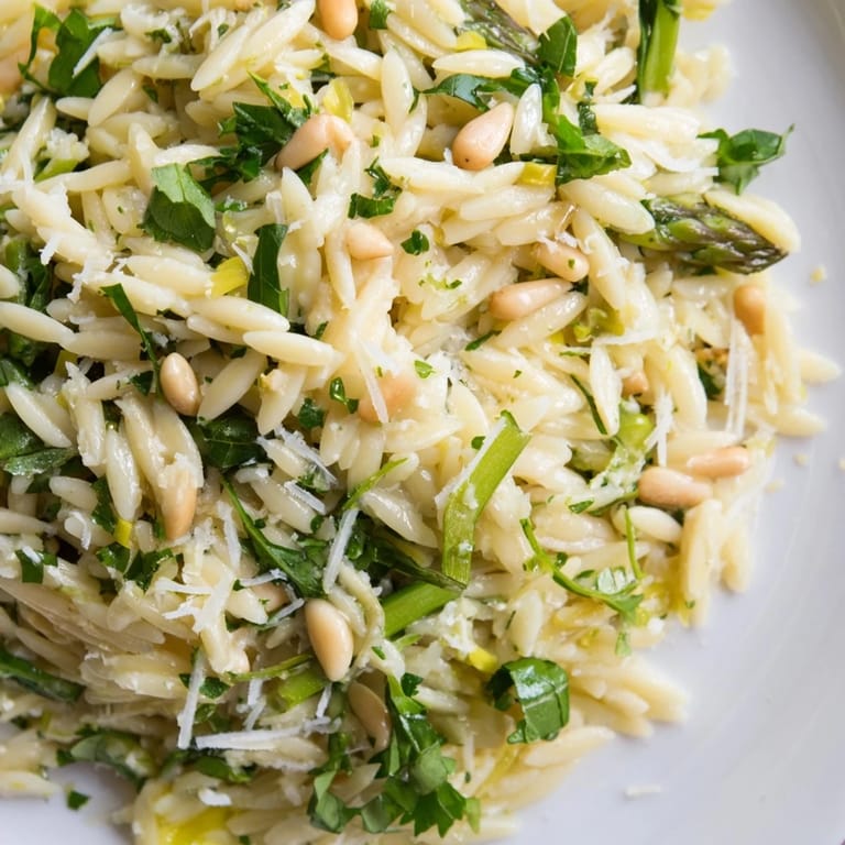 Tender orzo pasta meets crisp shaved asparagus and nutty Parmesan in this refreshing Asparagus Lemon Orzo Salad, with a zesty lemon–olive oil dressing and optional pine nuts for a delightful spring crunch.